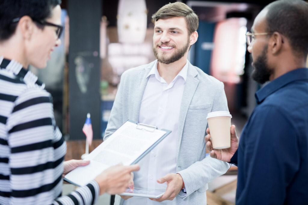 Business professional promoting a brand to a customer at a local community event.